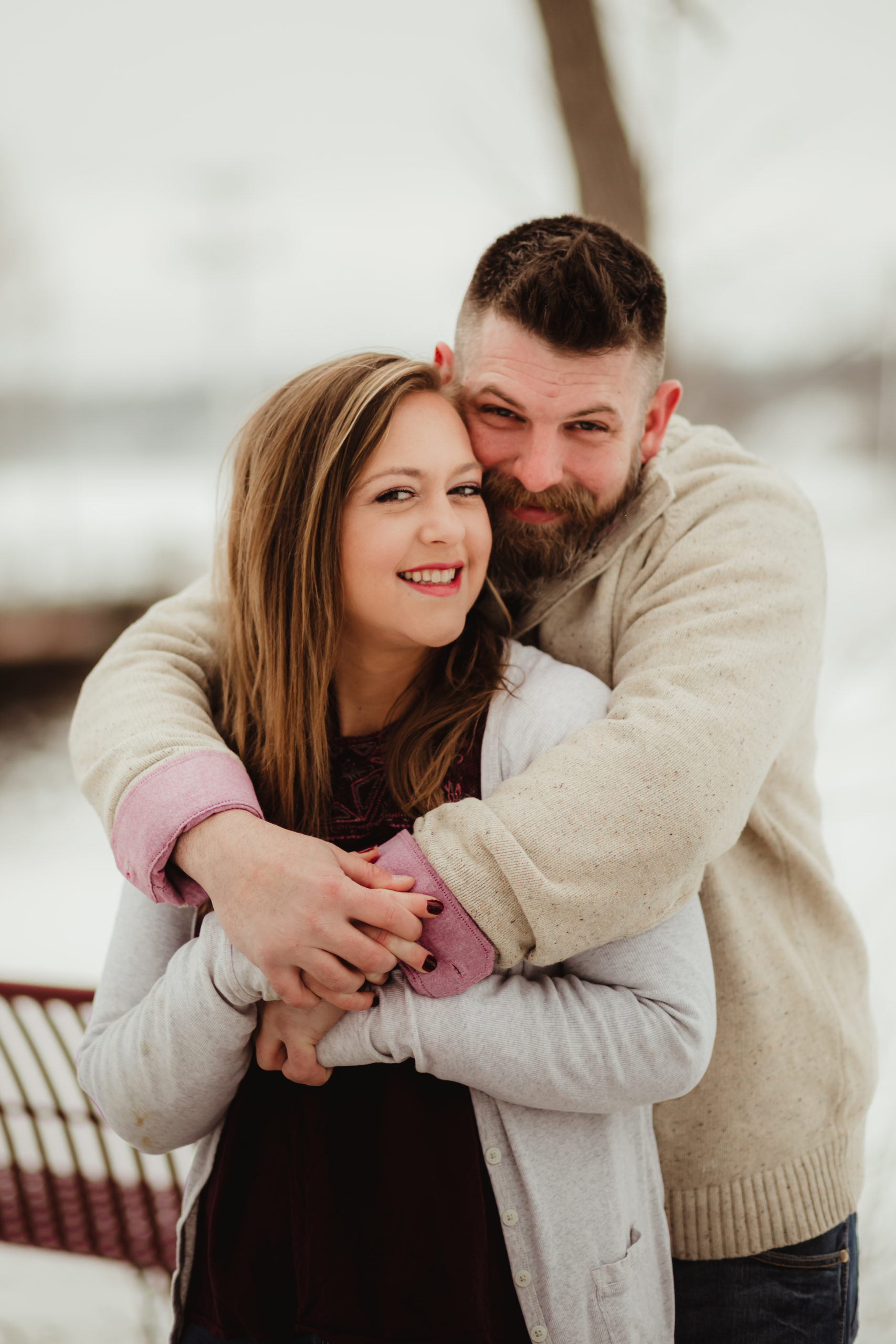 couple hugging in Hudson Wisconsin for their engagement session
